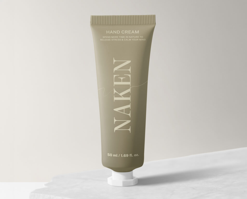 A beauty product tube of cream, with the packaging and brand displaying minimalist design, reading "Naken" in an elegant serif font at a large size with an olive green background color.