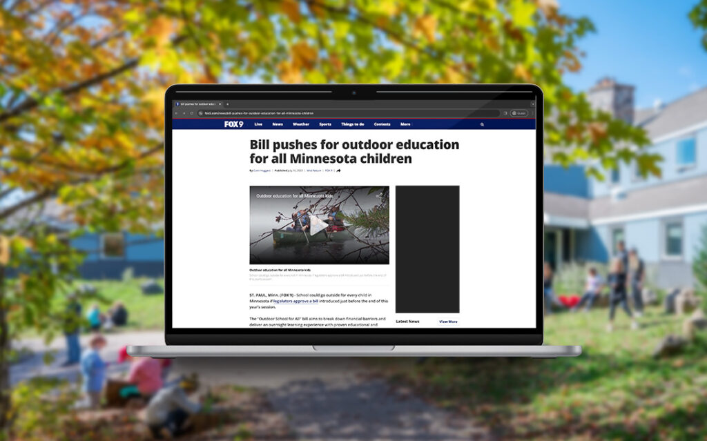 Laptop screen displaying a news article titled 'Bill Pushes for Outdoor Education for All Minnesota Children,' highlighting legislative efforts to promote outdoor learning opportunities statewide.