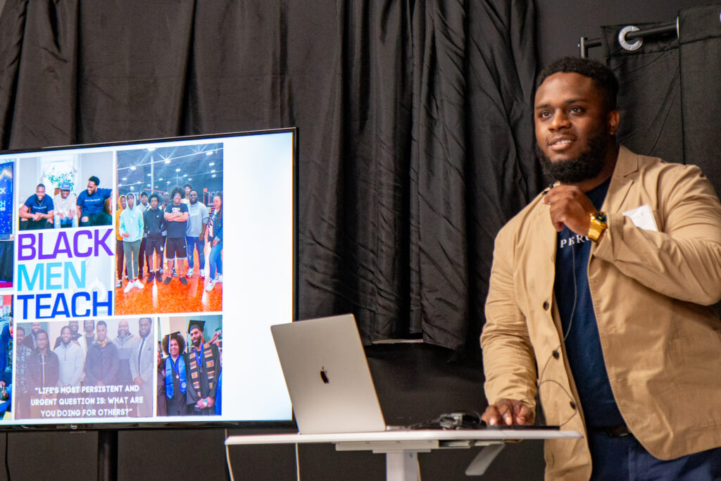 A man makes a presentation about the organization Black Men Teach.