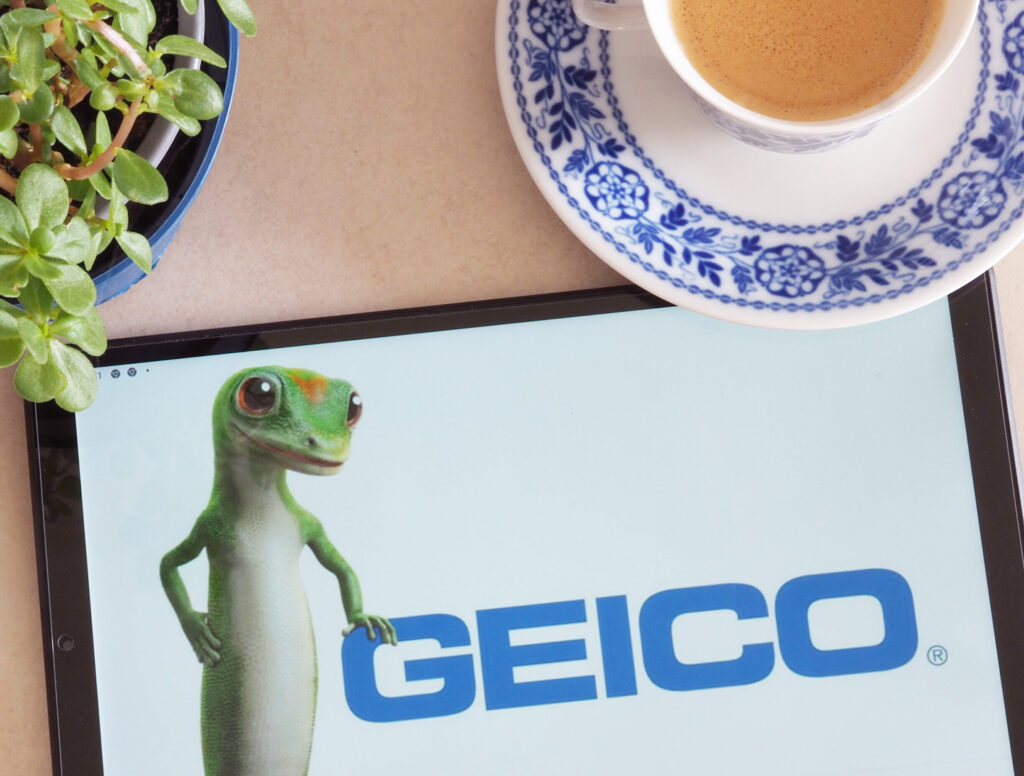 Tablet displaying the GEICO gecko mascot and GEICO logo