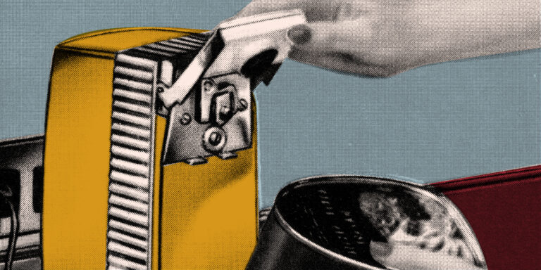 close up of a hand using a can opener